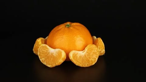 Mandarin with slices revolves around on a black background. Stock-Footage 151776468