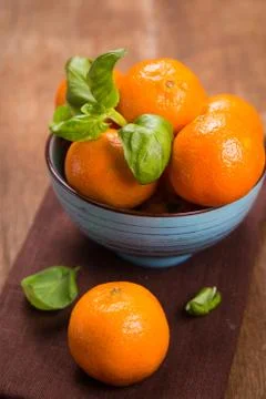 Mandarine with basil Stock Photos