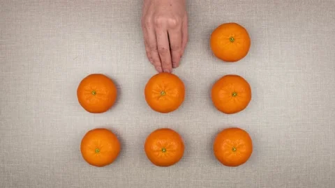 Mandarines appear from under a woman's hand. Stop motion 스톡 동영상 150400616