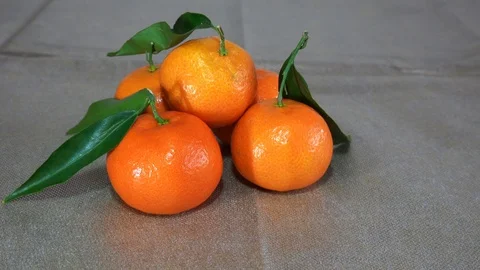 Mandarines Stack on a Table with another running and bumping against them 스톡 동영상 100156392
