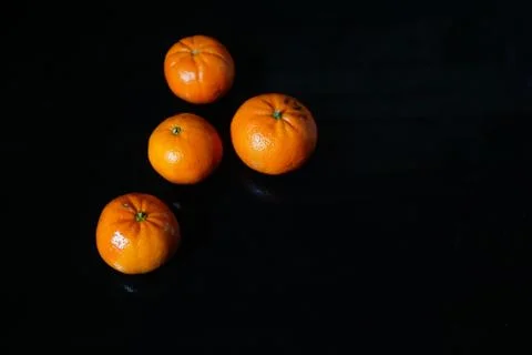 Mandarins on blackbackground. Stock Photos