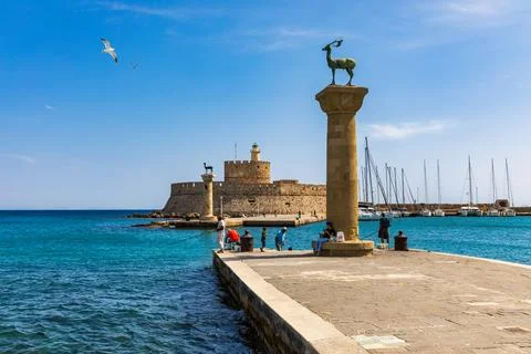 Mandraki port with deers statue, where The Colossus was standing and fort o.. Stock Photos
