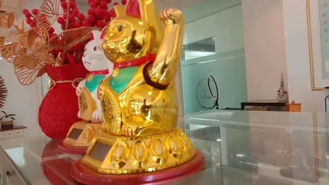 Maneki neko, a cat-shaped toy doll with moving hands Stock Footage 280280435
