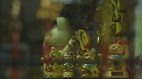 Maneki-neko or beckoning cats in shop window Stock Footage 89742844