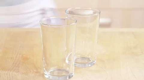 Mang lassi being poured into two glasses Video stock 24657354