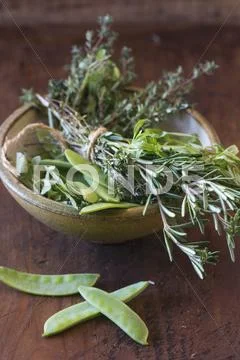 Mange Tout And A Bunch Of Herbs In A Ceramic Bowl