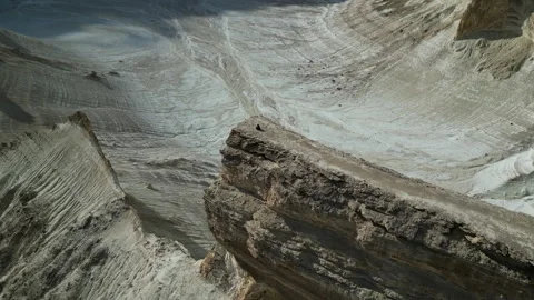 Mangistau. View of the cliffs. A man sitting on the edge of a cliff. Stock Footage 327618985