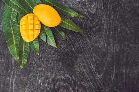 Mango and mango leaves on an old wooden background Stock Photos