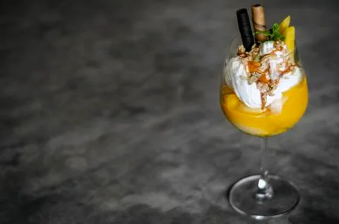 Mango and passion fruit tropical ice cream sundae in glass Stock Photos