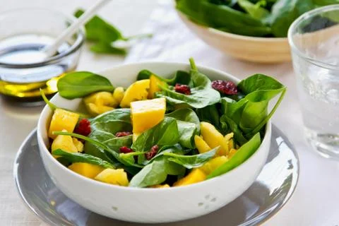 Mango and pineapple with spinach salad Stock Photos