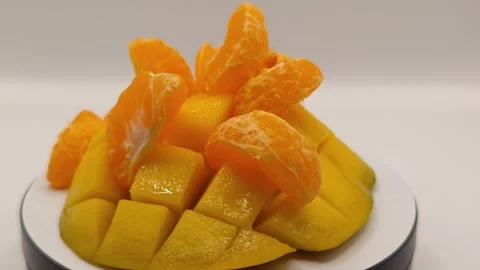 Mango and tangerine slices rotate Stock Footage 329645500