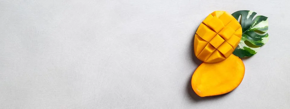 Mango background design concept. Top view Diced fresh mango fruit on gray tab Stock Photos