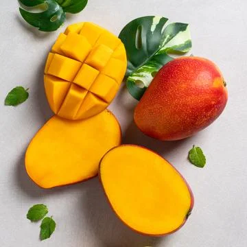 Mango background design concept. Top view Diced fresh mango fruit on gray tab Stock Photos