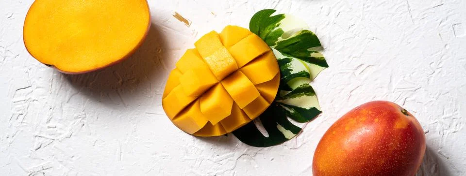Mango background design concept. Top view Diced fresh mango fruit on white .. Stock Photos