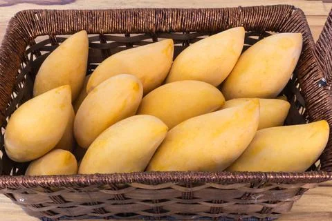 Mango in basket on table vintage Stock Photos