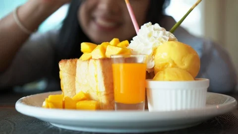 Mango bread toast ice-cream and whipping with woman enjoy eating Video stock 94138176