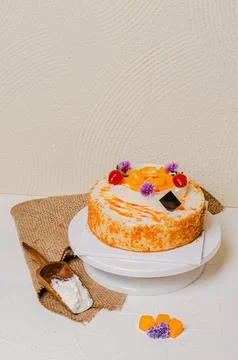 Mango Cake With Fresh Mango Slices And Strawberry Toppings On A White Plate.. Stock Photos