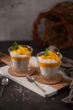 Mango Chia Pudding with Coconut and Mint in Glass Cups Stock Photos