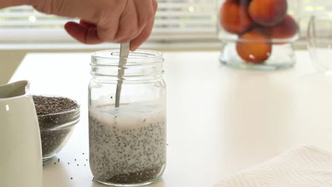 Mango Chia seed layered pudding smoothie. Mixing Chia seeds and yogurt Stock Footage 133276379
