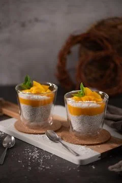 Mango Chia Seed Pudding with Coconut and Mint in Glass Cups Stock Photos
