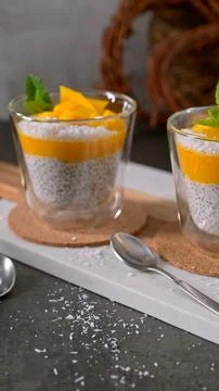 Mango Chia Seed Pudding with Coconut and Fresh Mint in Glass Cups Stock Photos