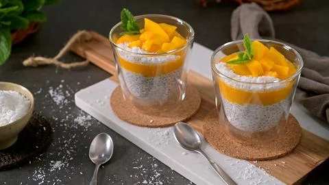Mango Chia Seed Pudding with Coconut and Fresh Mint in Glass Cups Stock Photos