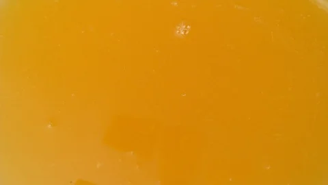 Mango chunks falling into mango juice in slow motion.  Shot with Phantom Flex 4K Stock Footage 130356656