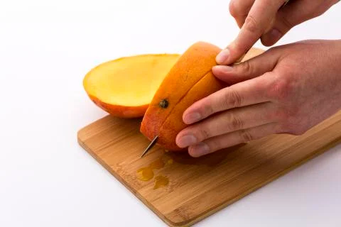 Mango cut into thirds with a second section Stock Photos