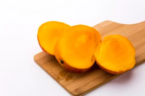 Mango cut into three equal slices Stock Photos