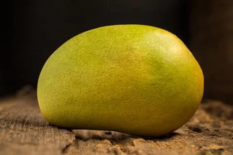 Mango on a dark wood background Stock Photos