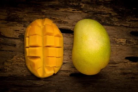 Mango on a dark wood background Stock Photos