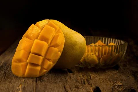 Mango on a dark wood background Stock Photos