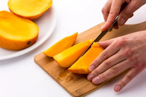 Mango divided into thirds being subdivided further Stock Photos