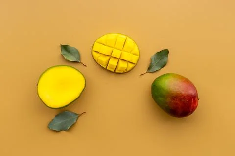 Mango fruit and mango cubes top view. Tropical fruits background Stock Photos
