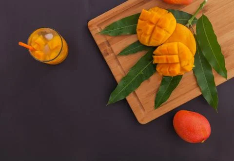 Mango fruit and mango drink on the wooden cutting board. Tropical fruit concept Stock Photos