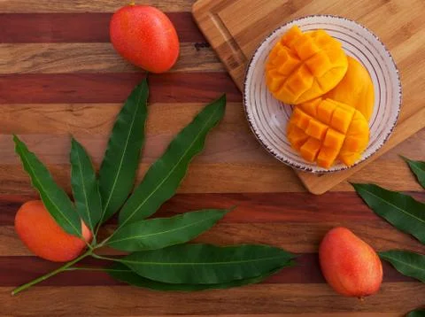 Mango fruit and mango drink on the wooden cutting board. Tropical fruit. Stock Photos