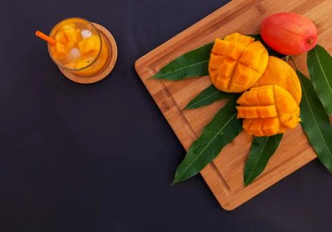 Mango fruit and mango drink on the wooden cutting board. Tropical fruit concept Stock Photos