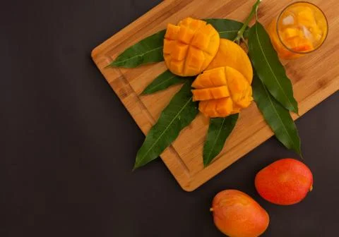 Mango fruit and mango drink on the wooden cutting board. Tropical fruit concept Stock Photos