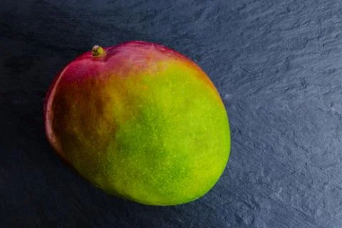 Mango Fruit on Black Rock Surface Background Stock Photos