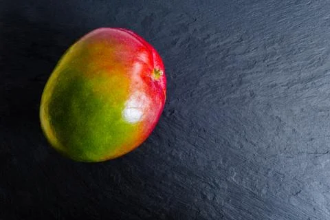 Mango Fruit on Black Rock Surface Background Stock-Fotos