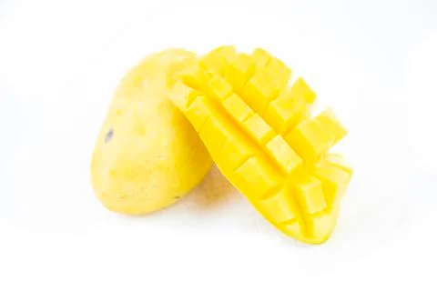 Mango fruit with mango cubes and slices. Isolated on a white background Stock Photos