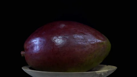 Mango fruit on a plate rotates in 4K Stock Footage 150727642