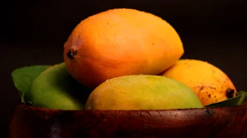 Mango fruit rotating on black background.indian kesar mango,View of whole man Stock Footage 197597069