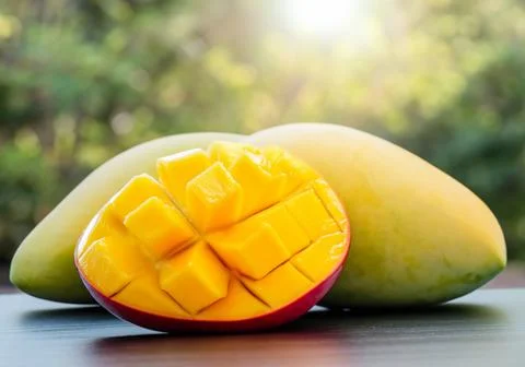 Mango fruit on a table in direct sunlight Stock Photos