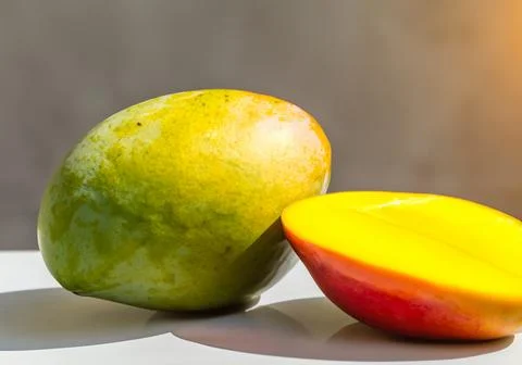Mango fruit on a table in direct sunlight Stock Photos