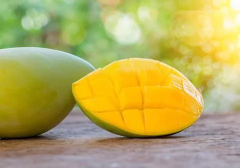 Mango fruit on a table in direct sunlight Stock Photos