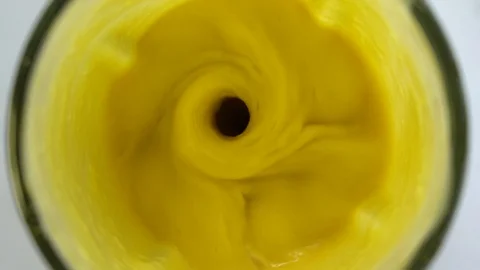 Mango fruit with white coconut milk blended up into a healthy yellow smoothie Stock Footage 102644854