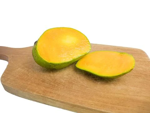 Mango halved placed on wood. so that the inside is visible in orange .isolate Stock Photos