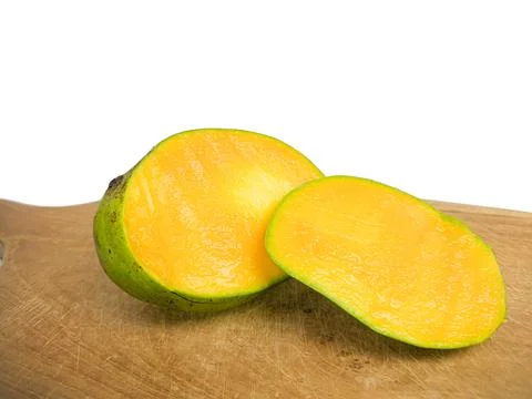 Mango halved placed on wood. so that the inside is visible in orange . Stock Photos