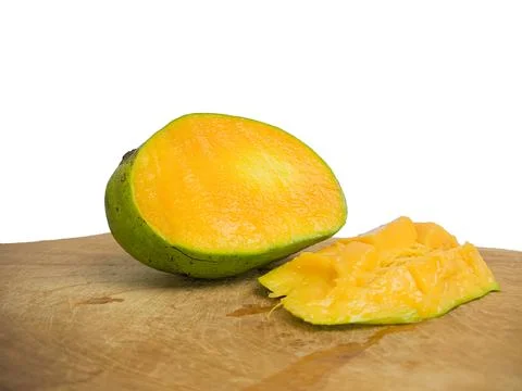 Mango halved placed on wood. so that the inside is visible in orange . Stock Photos